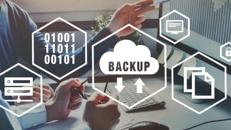 Backup and recovery icons for computer overlaid on people working on computers